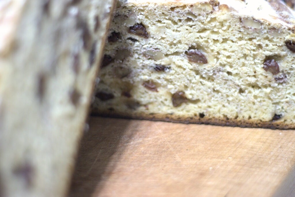 bread sliced in half with raisins and walnuts