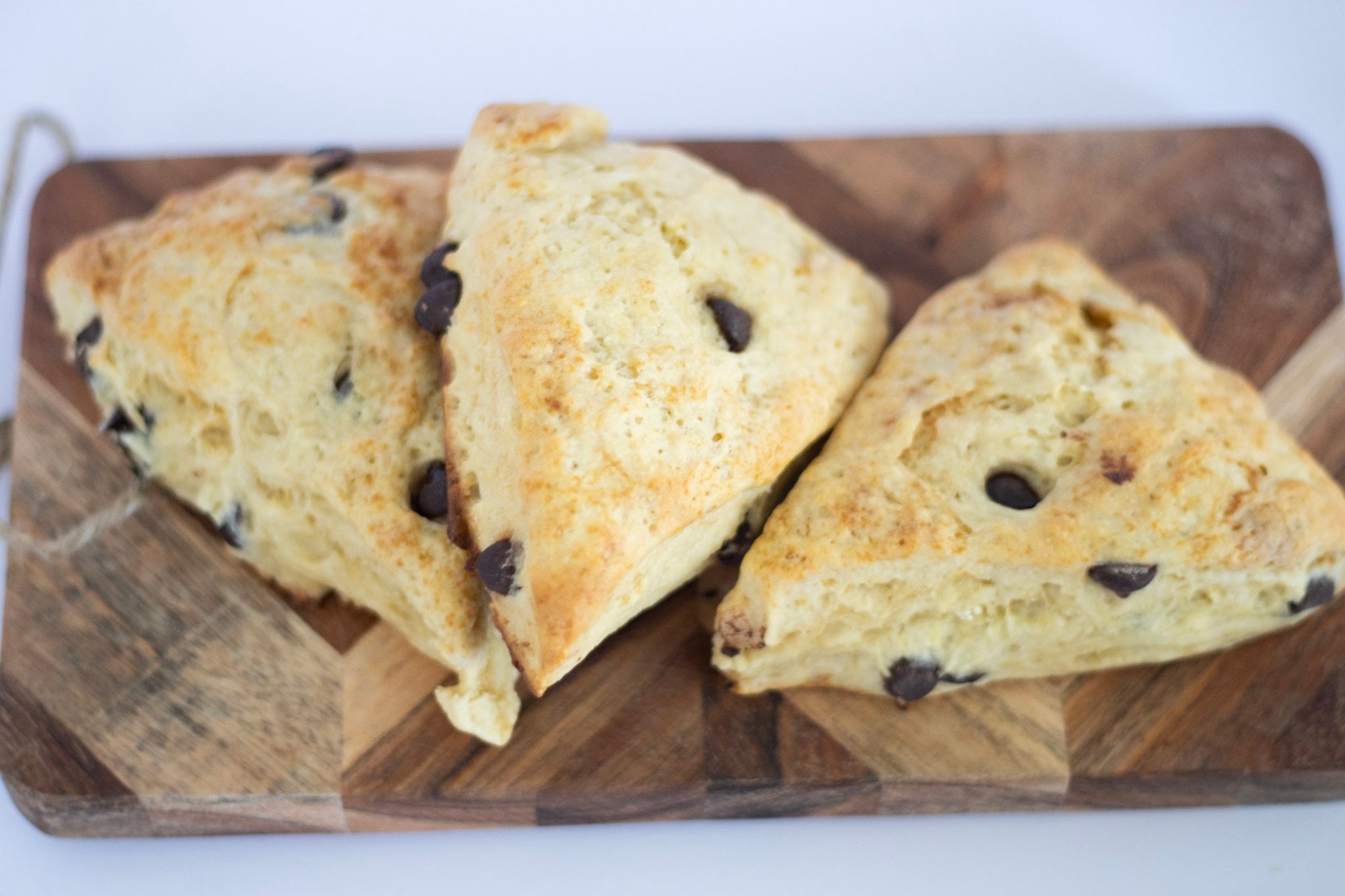 3 scones on a cutting board.
