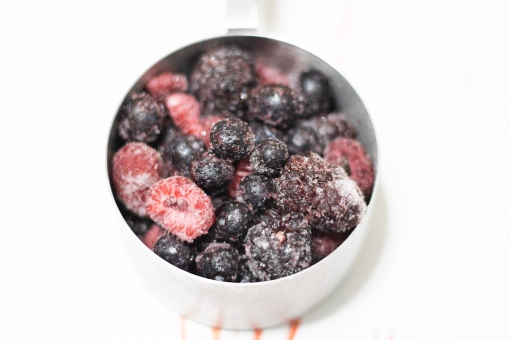 frozen berries in measuring cup