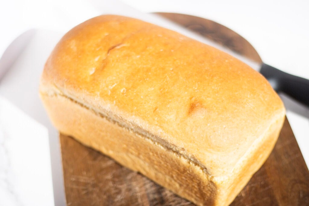 loaf of bread uncut on cutting board