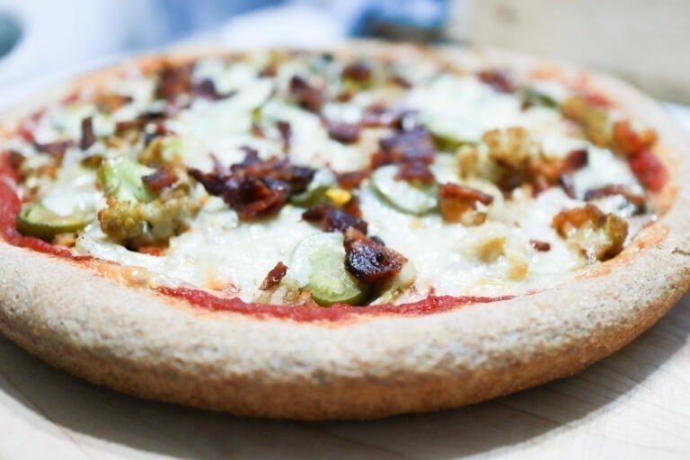 finished pizza on cutting board