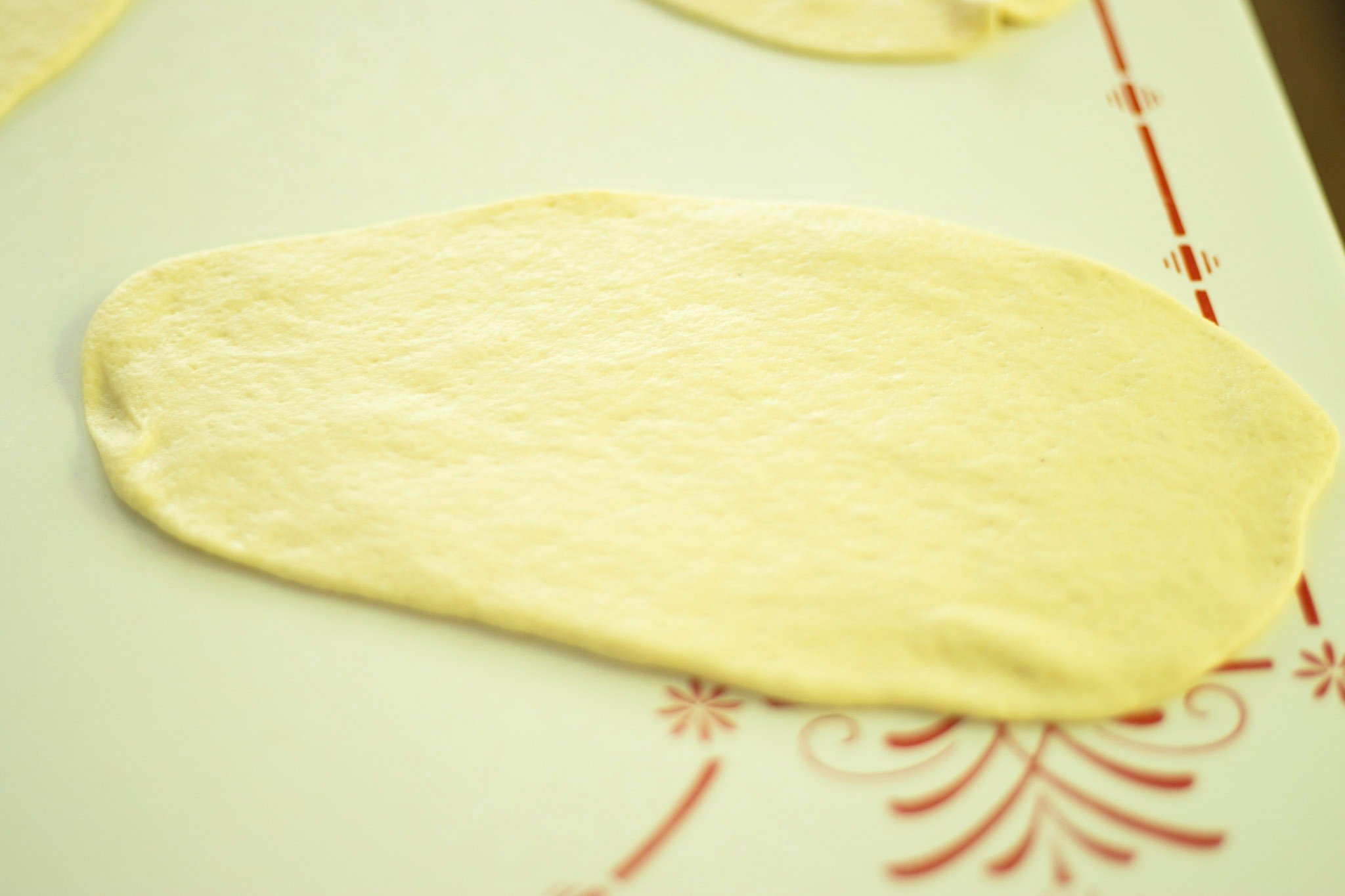 sourdough flatbread dough rolled out before cooking
