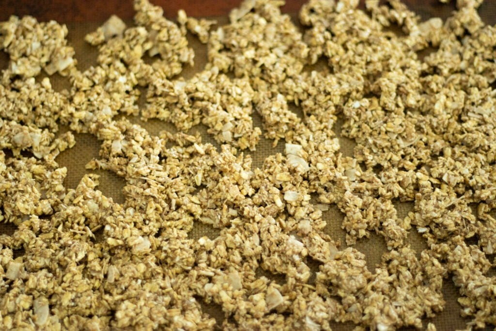 unbaked sourdough granola on baking sheet ready for the oven