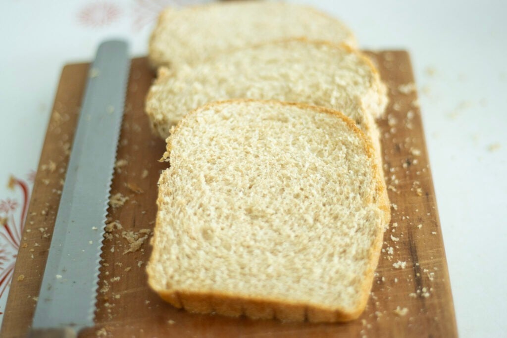 sliced bread on a cutting board with a knife