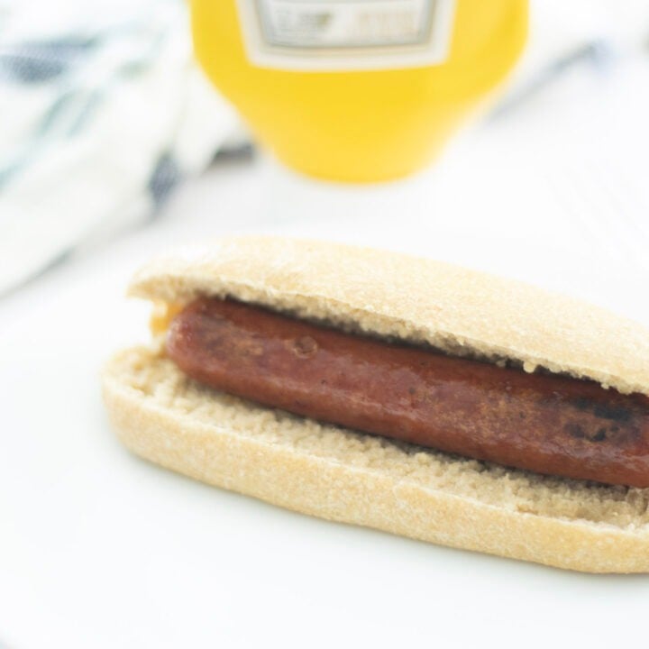 hot dog with mustard in the background