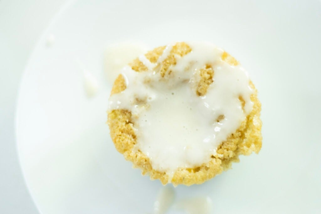 overhead shot of sourdough blueberry lemon cupcake with lemon glaze on top