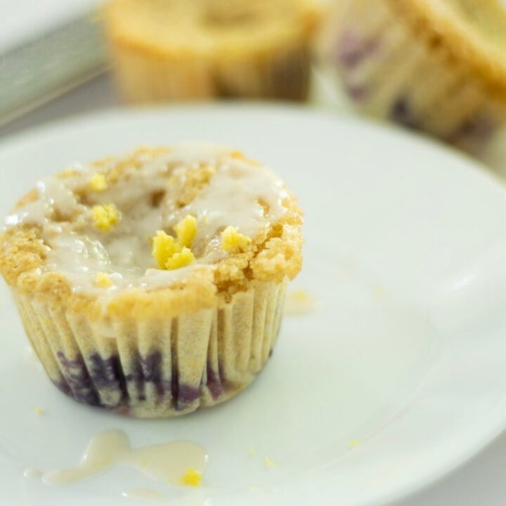 blueberry cupcake on plate with cupcakes in background and a lemon half