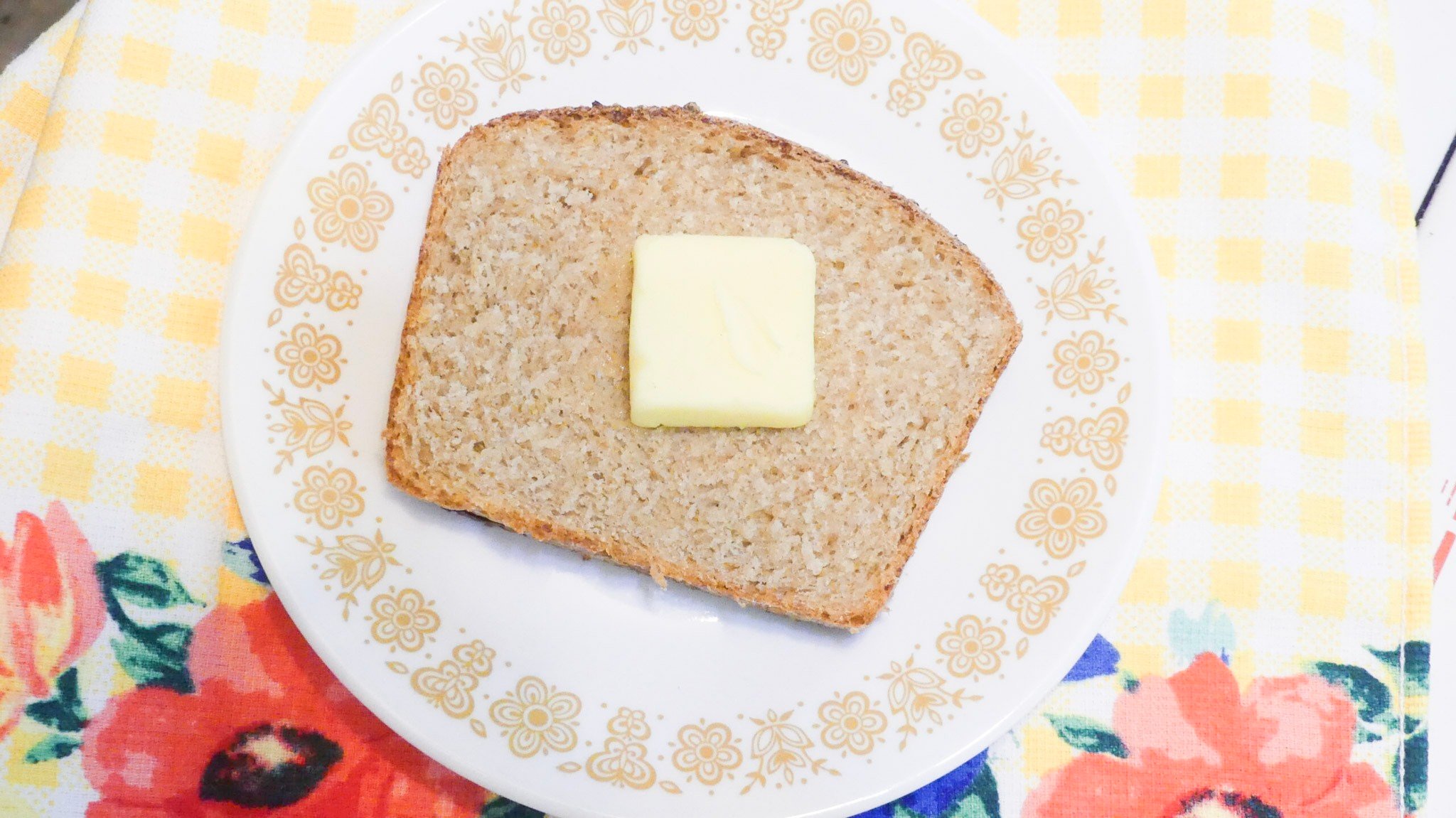 slice of bread with butter on it on a plate