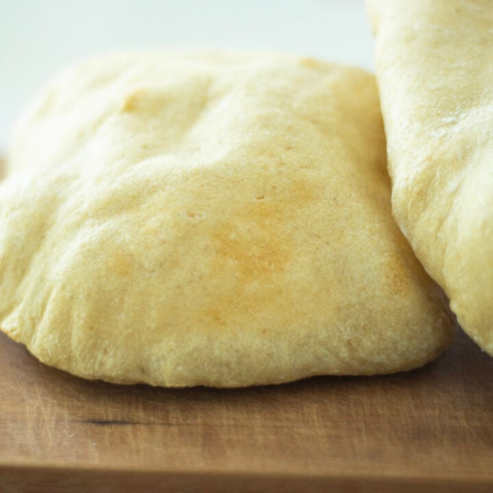 2 sourdough pitas on a cutting board