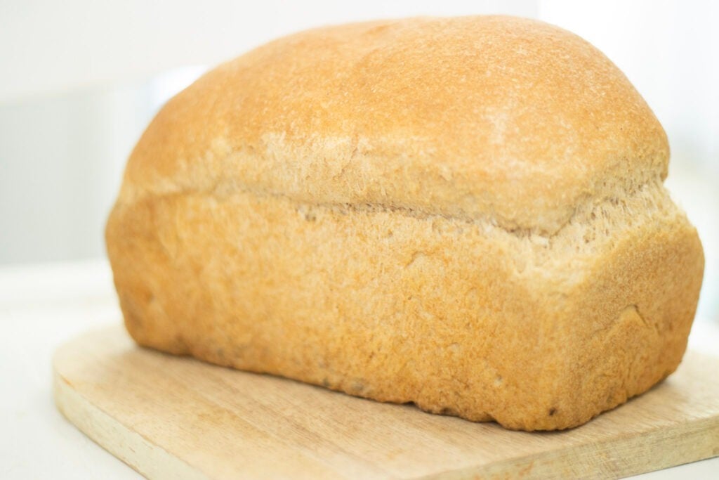 loaf of sourdough bread made with yeast on cutting board