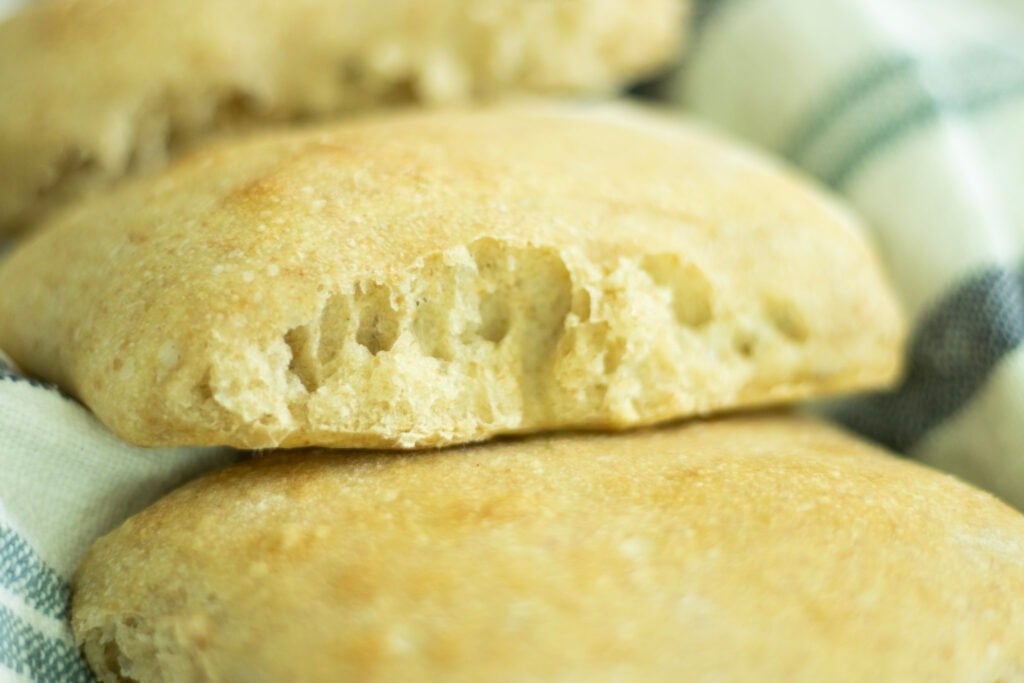 the side of a sourdough ciabatta roll showing the fluffiness of the interior