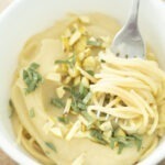 bowl of pasta with pumpkin pasta sauce, sage, and chestnuts