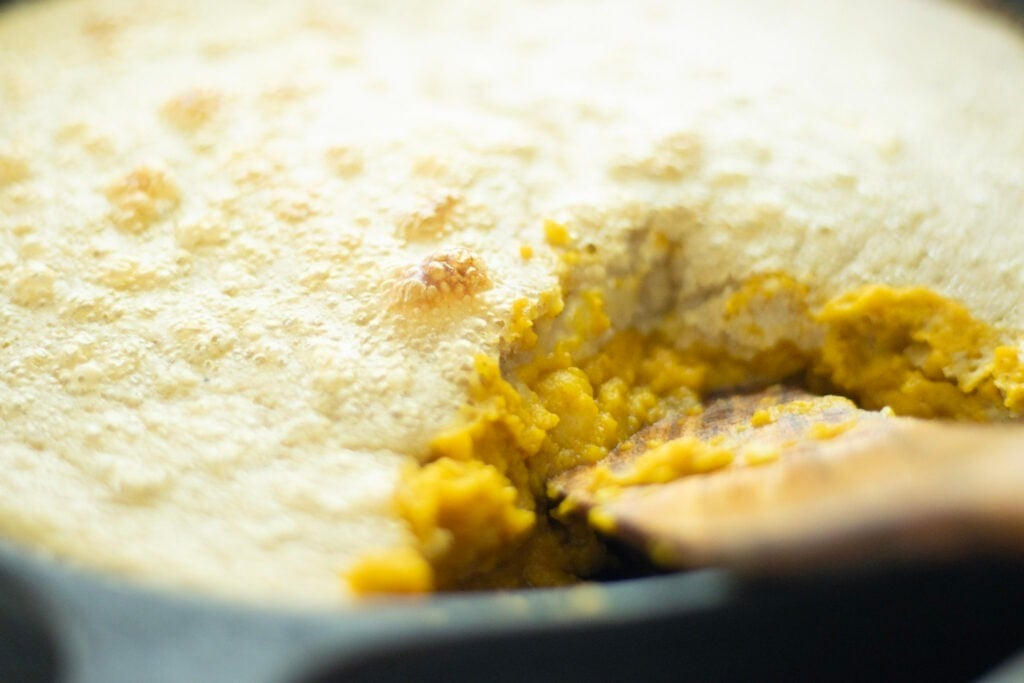 side pic of sourdough pumpkin cobbler with a slice taken out
