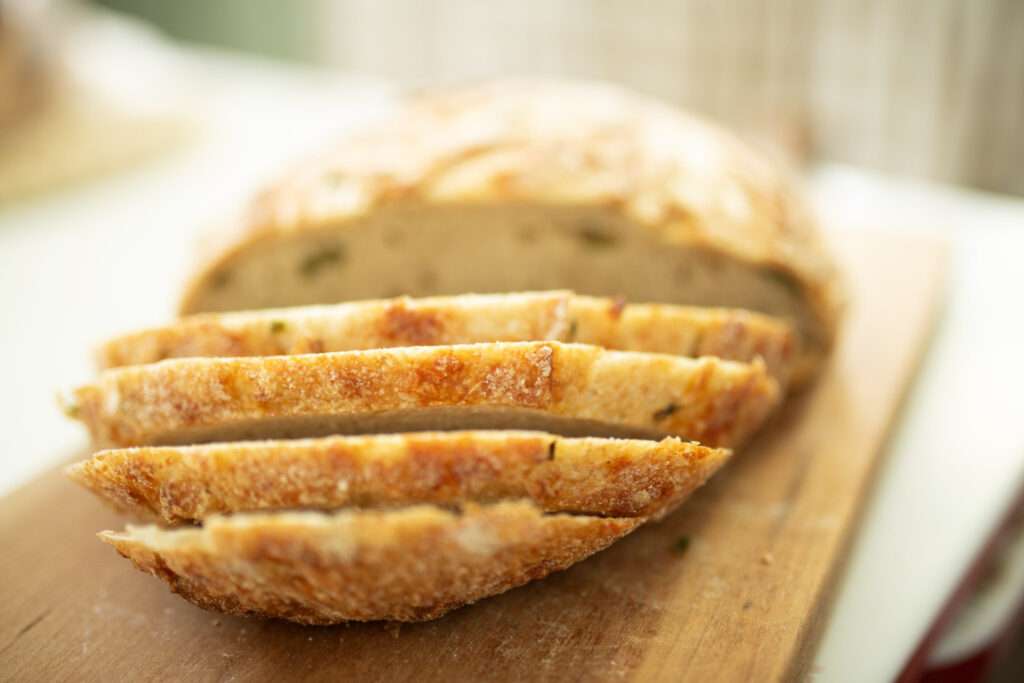 foreground shot of slices of sourdough jalapeno cheddar loaf