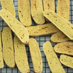 sourdough pumpkin biscotti stacked on a wire rack