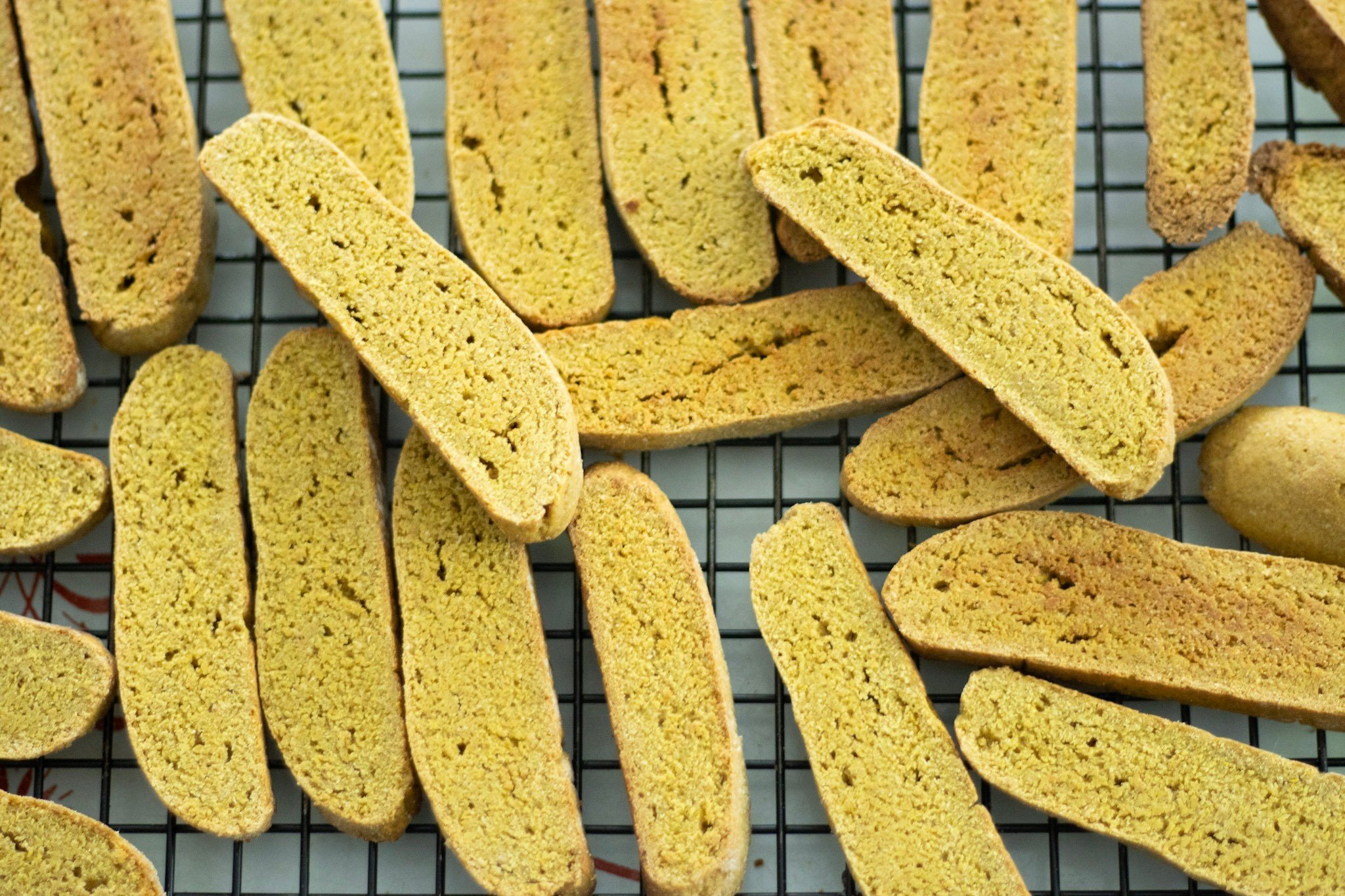 sourdough pumpkin biscotti stacked on a wire rack