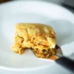 close shot of slice of sourdough sweet potato casserole on white plate