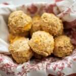 Over head shot of a basket of sourdough cheddar herb biscuits