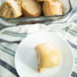 overhead of freshly milled sourdough dinner roll on white plate
