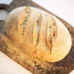 overhead of sourdough garlic herb loaf of bread