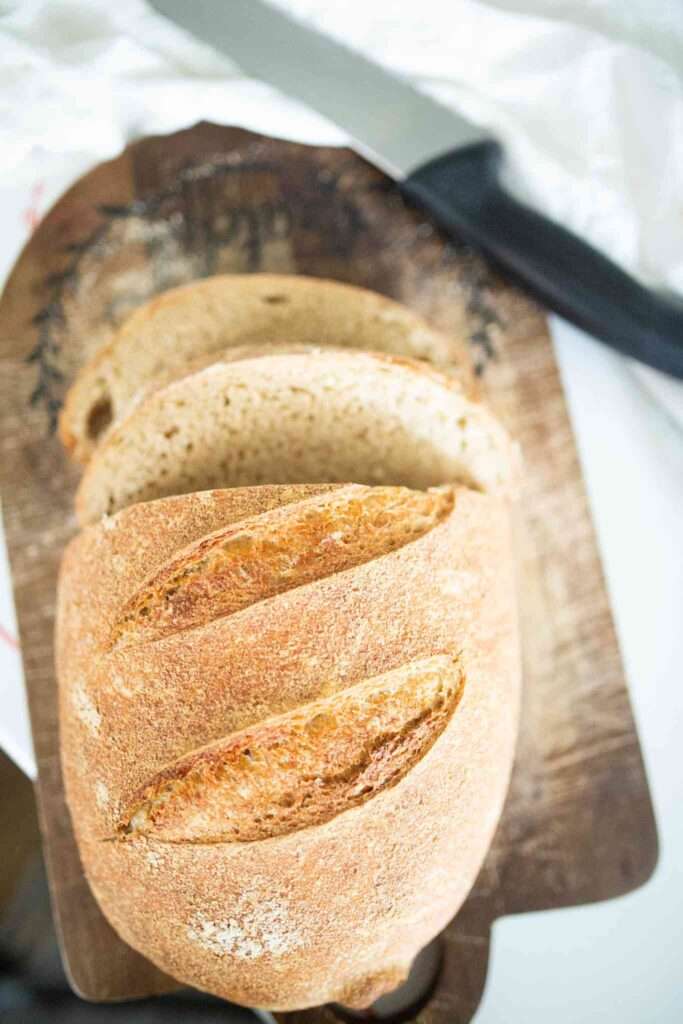 beginner fresh milled sourdough loaf sliced on cutting board