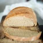 a photo of beginner fresh milled sourdough bread sliced to show crumb