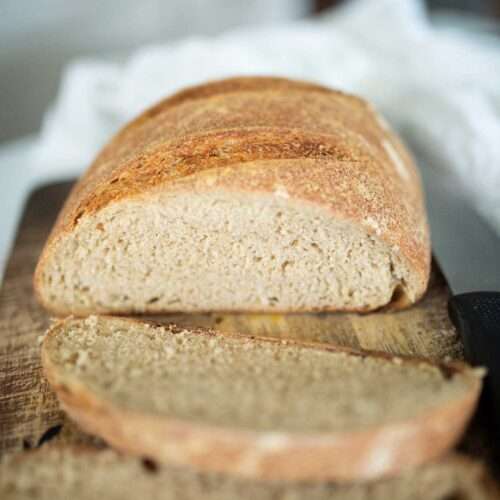 a photo of beginner fresh milled sourdough bread sliced to show crumb