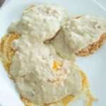 overhead view of sourdough gravy over eggs and sourdough biscuits