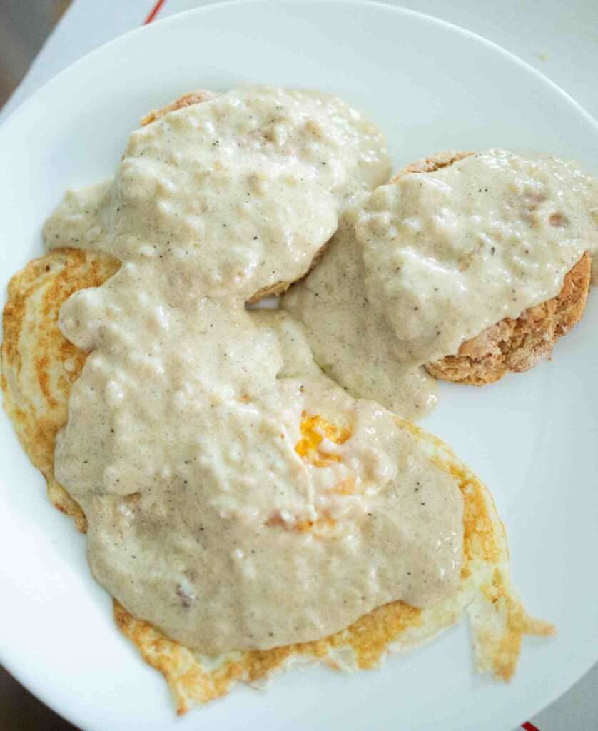 overhead view of sourdough gravy over eggs and sourdough biscuits