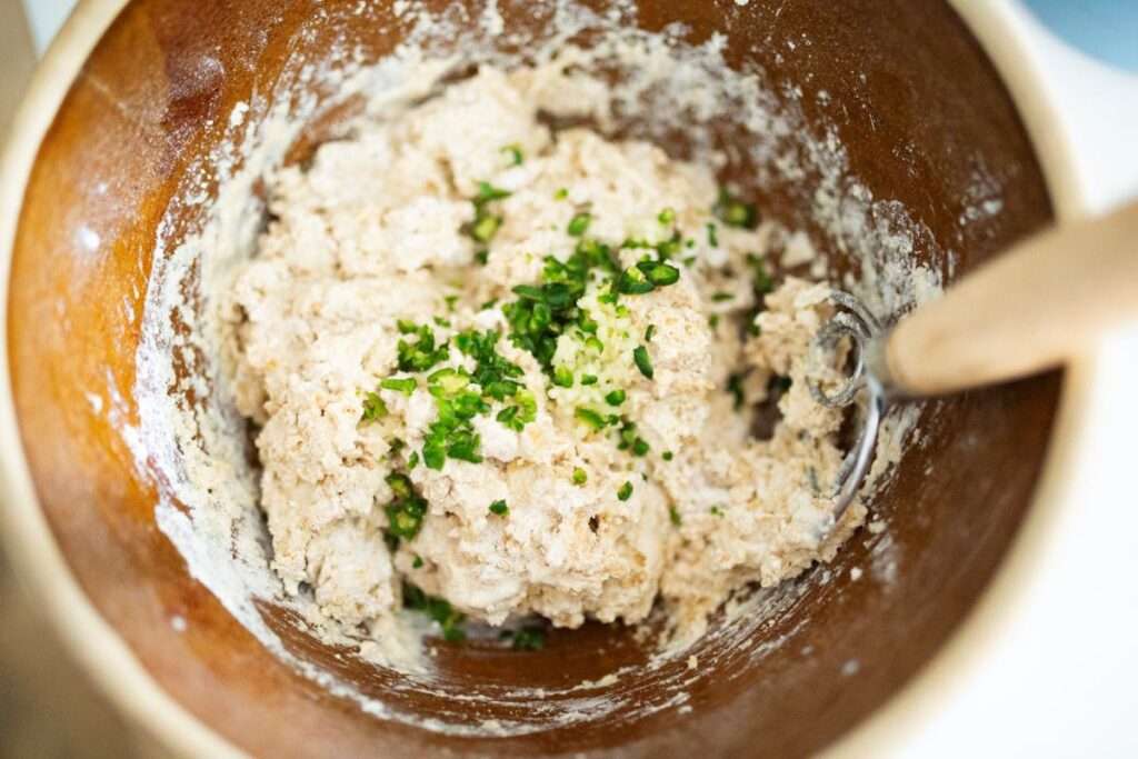 sourdough jalapeno garlic scone dough in a brown bowl