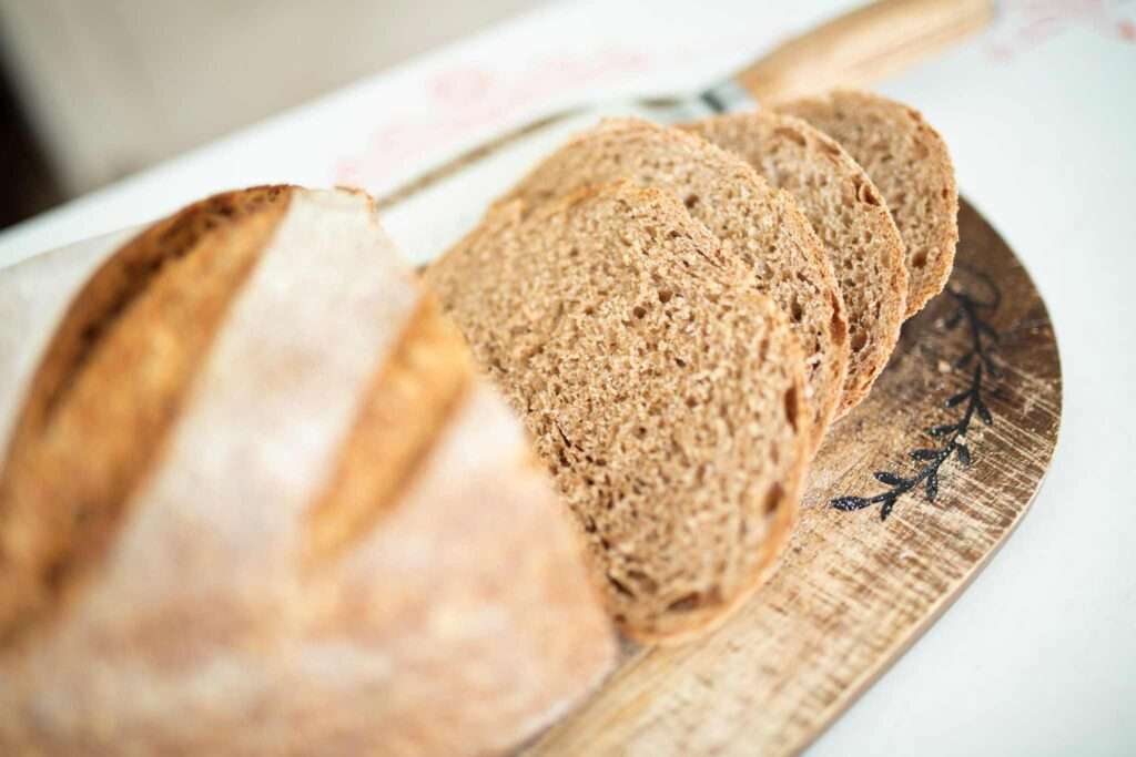 slices of spelt sourdough artisan bread on a wooden cutting board