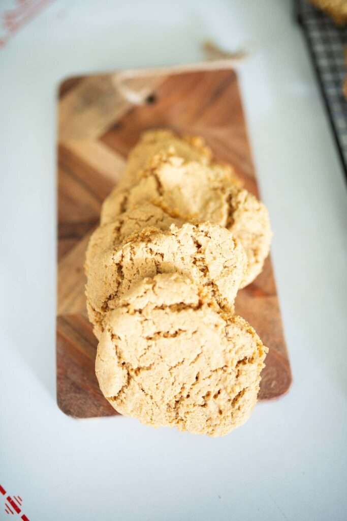 Einkorn peanut butter cookies lined up on a wooden cutting board