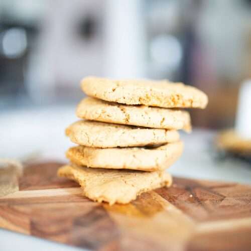This is a vertical stack of einkorn peanut butter cooking on a wooden cutting board