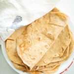 Sourdough Einkorn tortillas on a plate with top tortilla folded