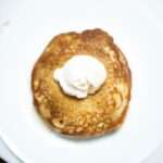 Overhead photo of buckwheat pancakes with a dollup of yogurt on top.