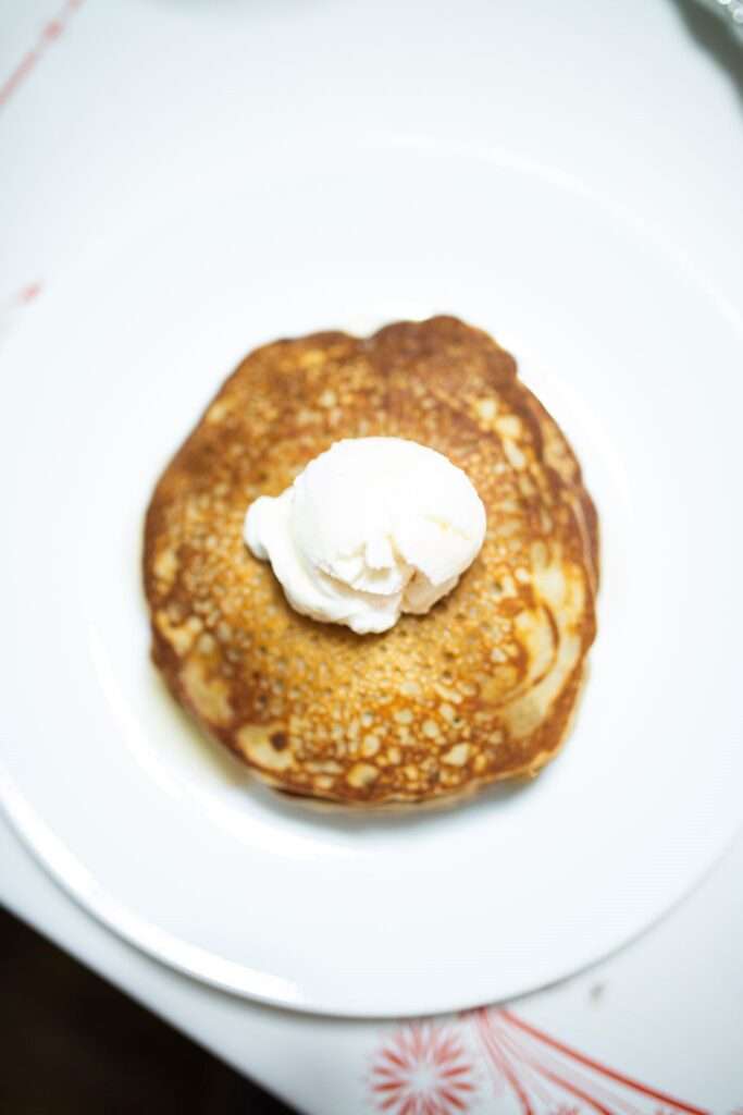 Overhead photo of buckwheat pancakes with a dollup of yogurt on top.