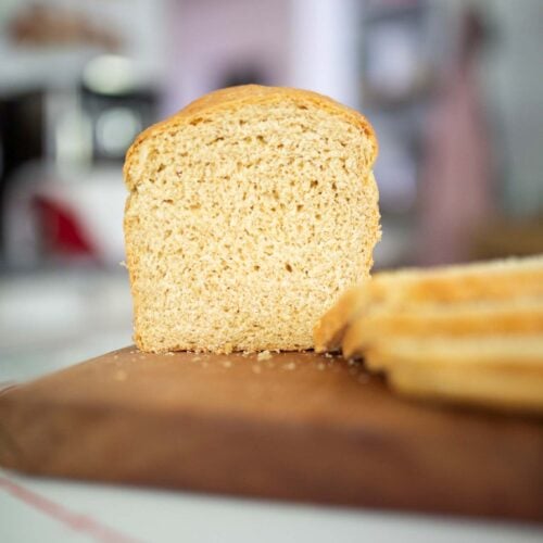 Sliced Khorasan sandwich loaf on a cutting board.