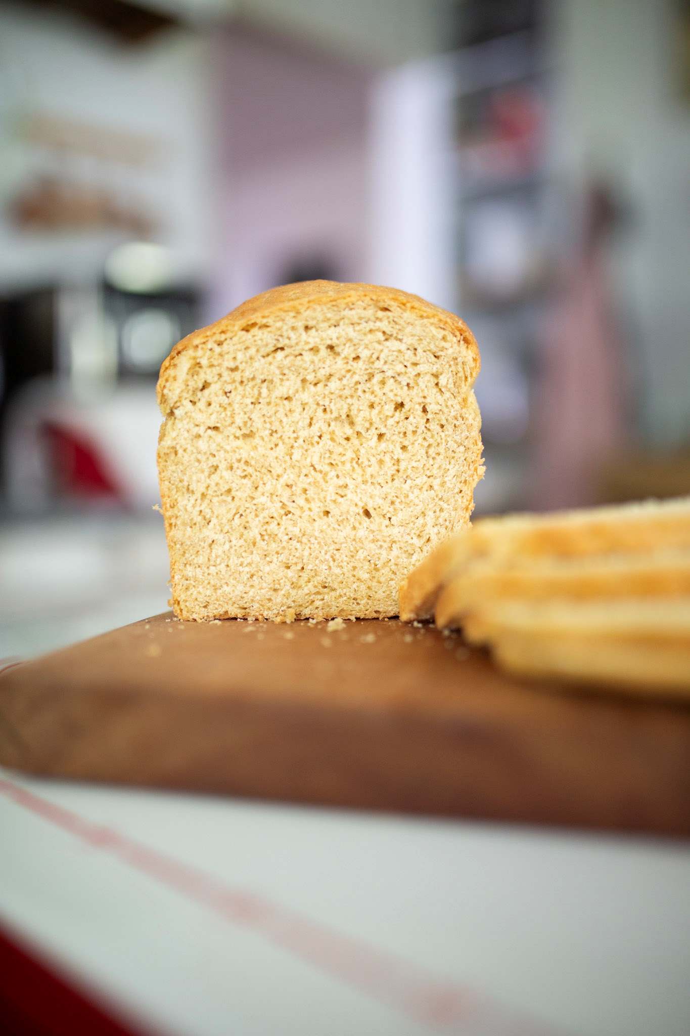 Sliced Khorasan sandwich loaf on a cutting board.