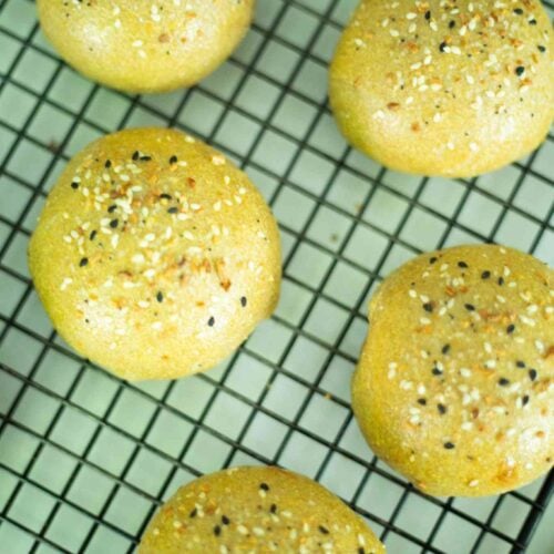 Overhead photo of sourdough hamburger buns on a wire rack.