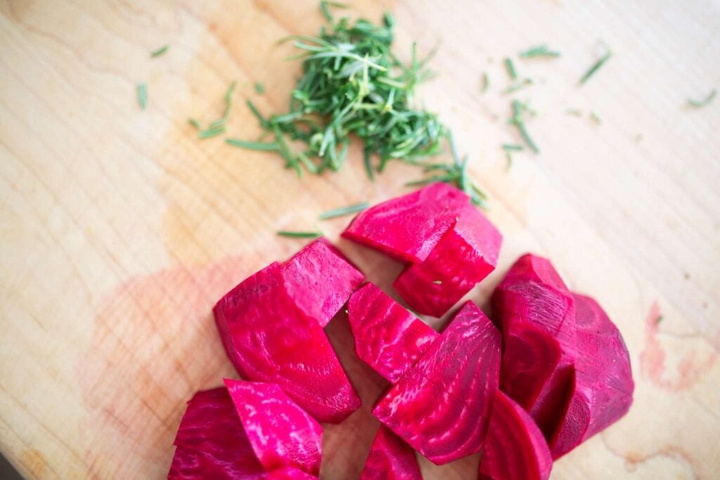 Beets and Rosemary on a cutting board.
