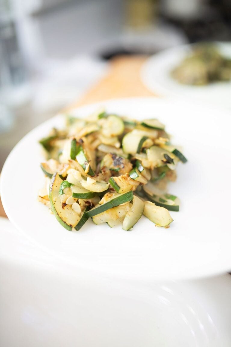 A serving of golden brown sauteed zucchini on a plate.