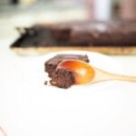 a slice of fresh milled chocolate cake with a piece on a wooden spoon