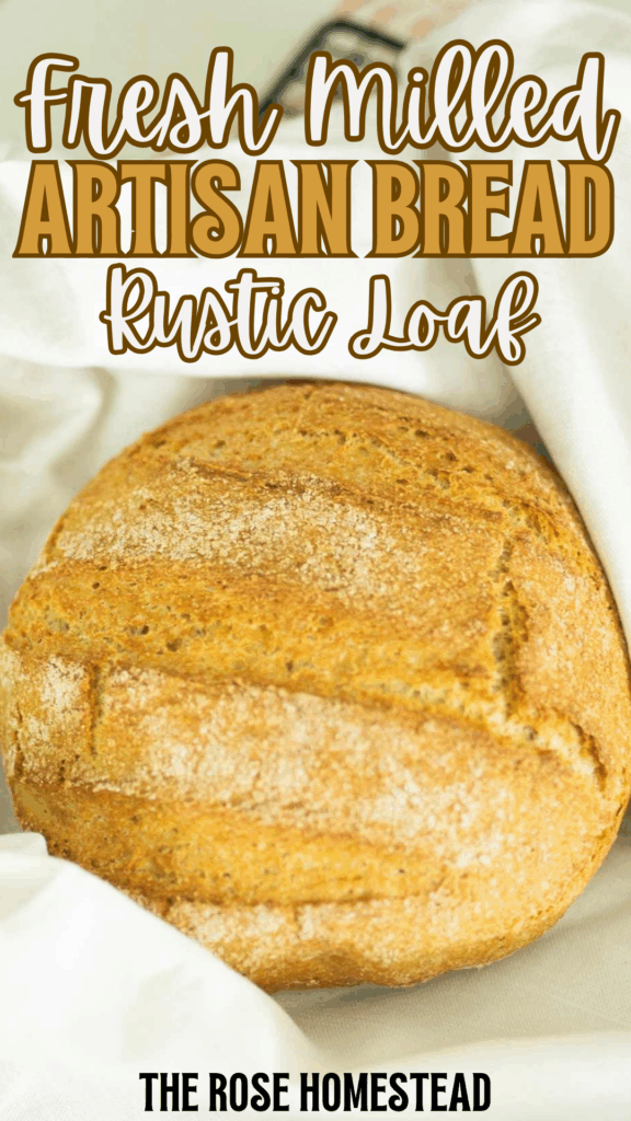 A piinterest pin for fresh milled artisan bread with a photo of the loaf in a white towel. The text reads fresh milled artisan bread, rustic loaf.