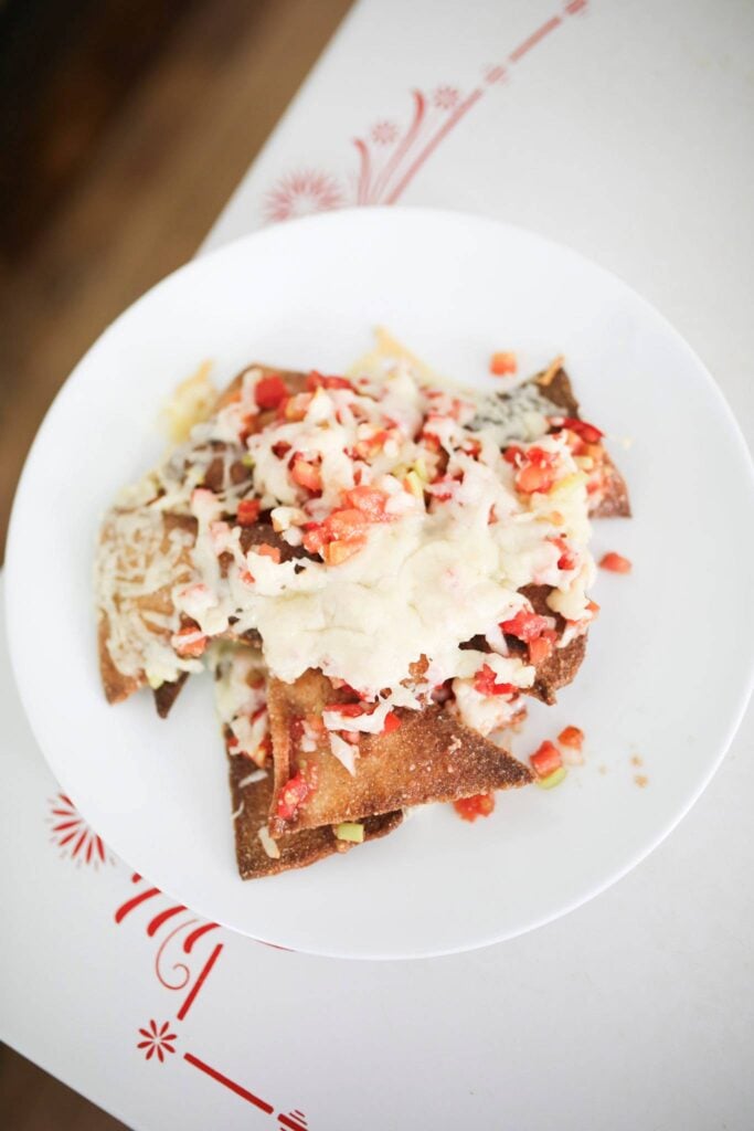 This is an overhead photo of nachos that are made with sourdough tortilla chips.