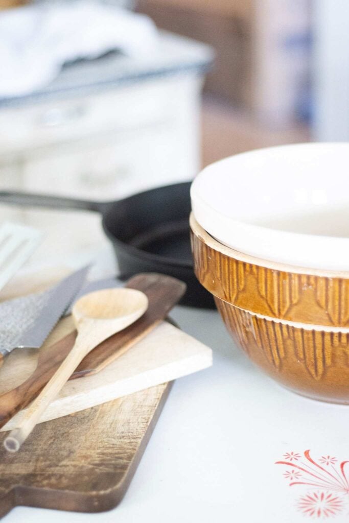 Essential tools for the from scratch kitchen. Mixing bowls, cutting boards, cast iron, and utensils
