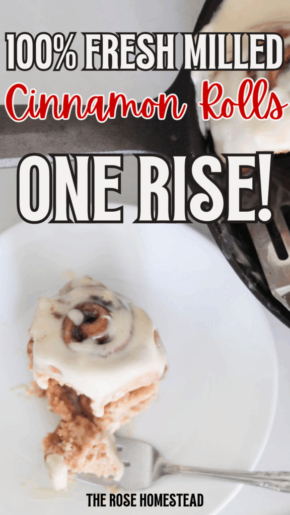 This is a Pinterest pin for fresh milled cinnamon rolls with a photo of a cream cheese frosted cinnamon roll on a white plate with a fork. The text reads 100% fresh milled cinnamon rolls, one rise.