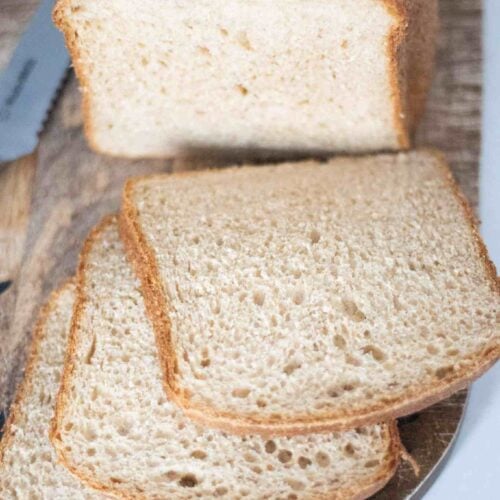 Loaf of fresh milled sourdough bread sliced on a cutting board.