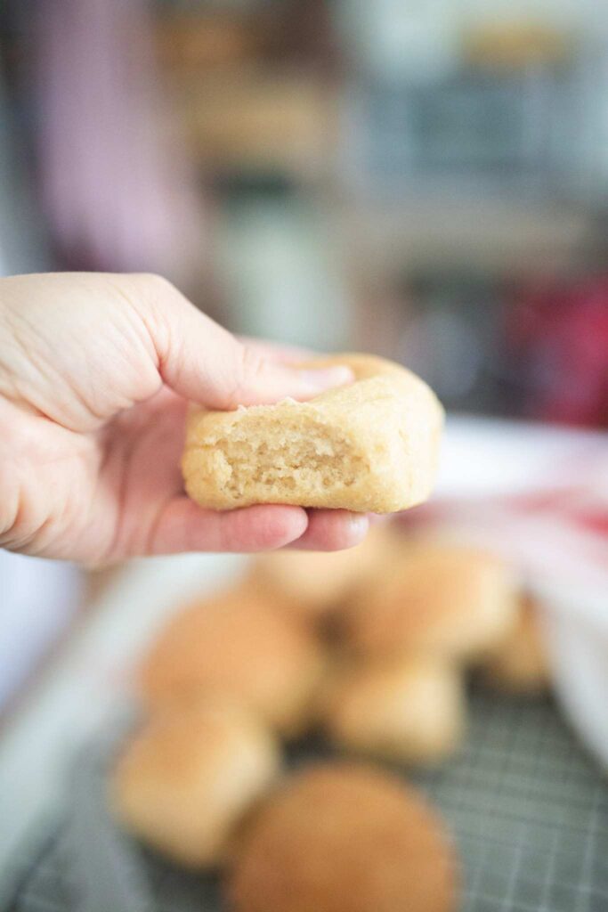 Hand squeezing a dinner roll.