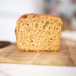 The crumb of a loaf of bread that is sitting on a cutting board.