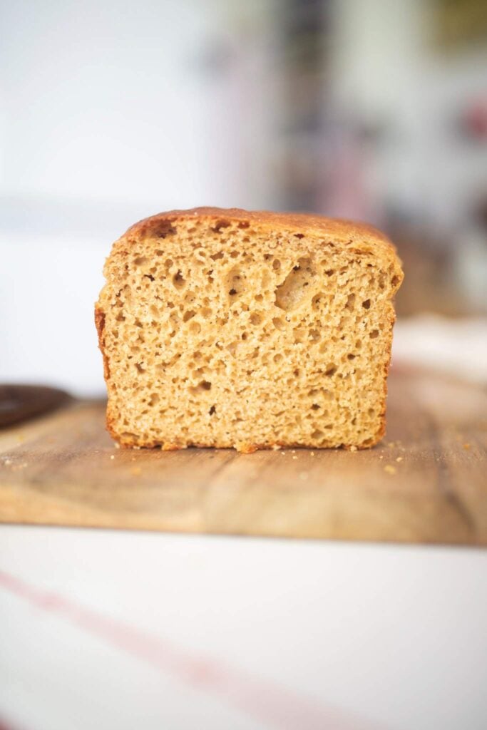 The crumb of a loaf of bread that is sitting on a cutting board.